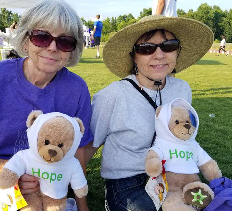 Ball-Fall-2017-3Cancer-survivors-and-long-time-Relayers-from-the-Sun-City-team-l-Josie-Knill-and-r-Marilyn-Borrelli-cancer-survivors-with-their-Extended-Stay-America-Hope-Bears