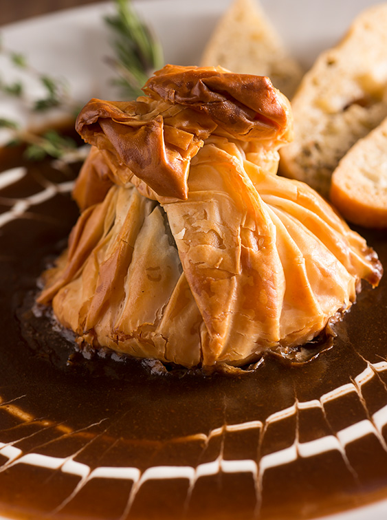 The gebackener ziegenkäse appetizer features goat cheese, spinach and sundried tomatoes wrapped in phyllo dough.